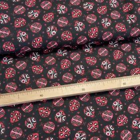 Fekete alapon népies katicás pamutvászon